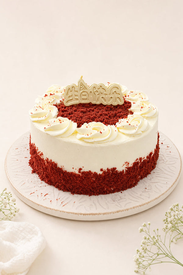 Studio hero image of a round red velvet cake with cream-colored piped frosting rosettes forming a swirl border